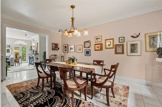 303 Schenley Rd, Squirrel Hill, PA 15217 - dining area with ornamental molding, light tile patterned floors, a fireplace, and a chandelier