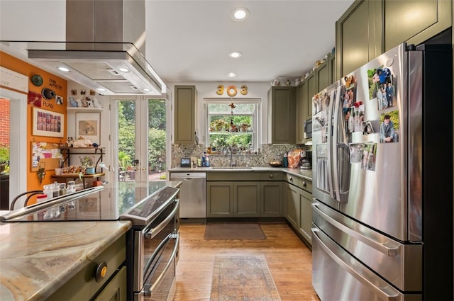 303 Schenley Rd, Squirrel Hill, PA 15217 - kitchen featuring stainless steel appliances, green cabinets, light wood-type flooring, recessed lighting, and backsplash