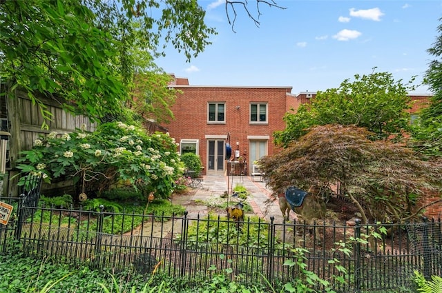 303 Schenley Rd, Squirrel Hill, PA 15217 - view of front of property with a fenced backyard, brick siding, and a patio