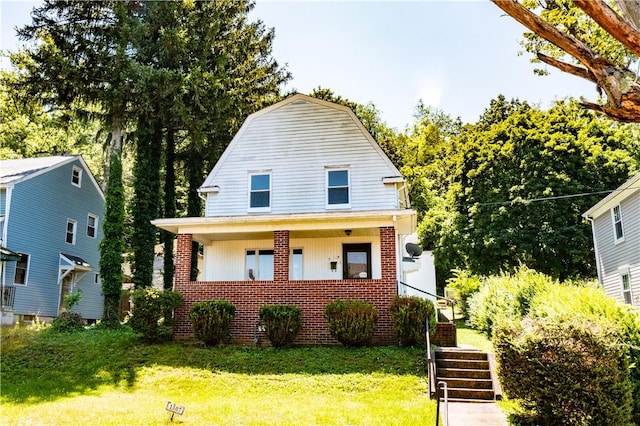1307 Wade St, Aliquippa, PA 15001 - dutch colonial with brick siding, a front lawn, a porch, a gambrel roof, and stairway