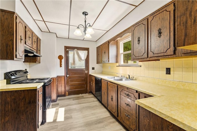 1307 Wade St, Aliquippa, PA 15001 - kitchen featuring black appliances, under cabinet range hood, light wood finished floors, a chandelier, and light countertops