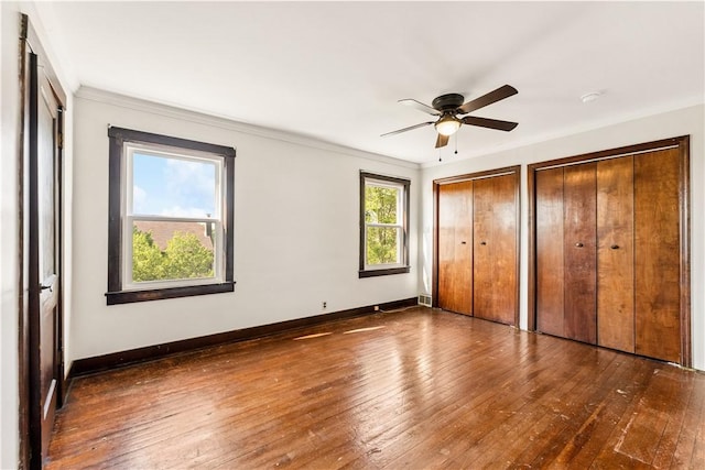 1307 Wade St, Aliquippa, PA 15001 - unfurnished bedroom with multiple closets, wood-type flooring, crown molding, and ceiling fan