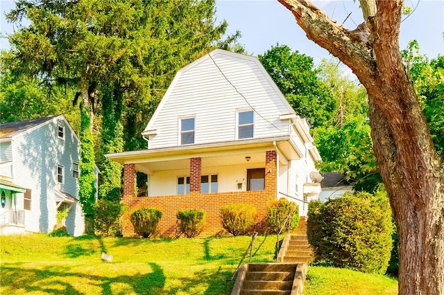 1307 Wade St, Aliquippa, PA 15001 - dutch colonial featuring brick siding, stairs, a front lawn, and a gambrel roof