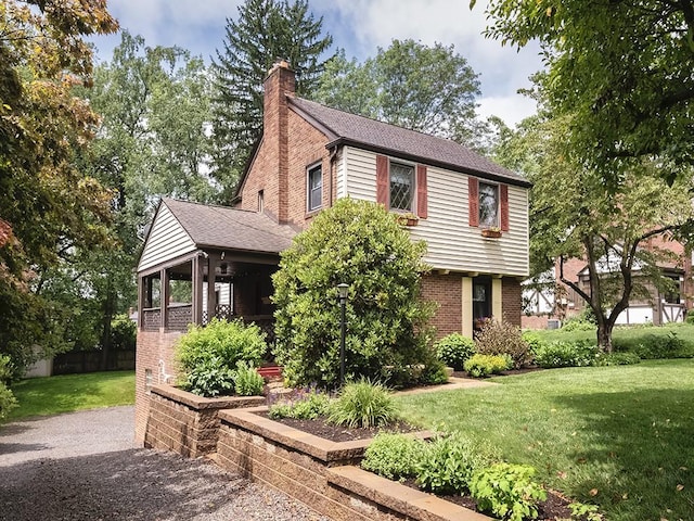 1907 Shaler Dr, Shaler, PA 15116 - colonial inspired home featuring brick siding, a front lawn, a chimney, and a shingled roof