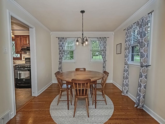1907 Shaler Dr, Shaler, PA 15116 - dining room featuring a chandelier, dark wood-type flooring, healthy amount of natural light, and ornamental molding