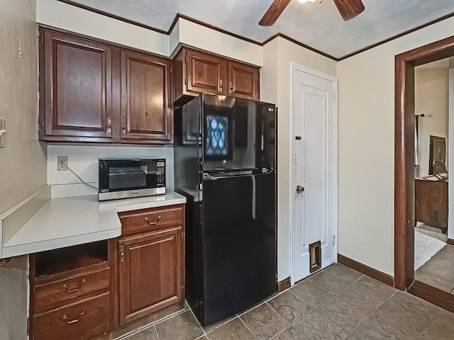 1907 Shaler Dr, Shaler, PA 15116 - kitchen with freestanding refrigerator, stainless steel microwave, light countertops, ceiling fan, and ornamental molding