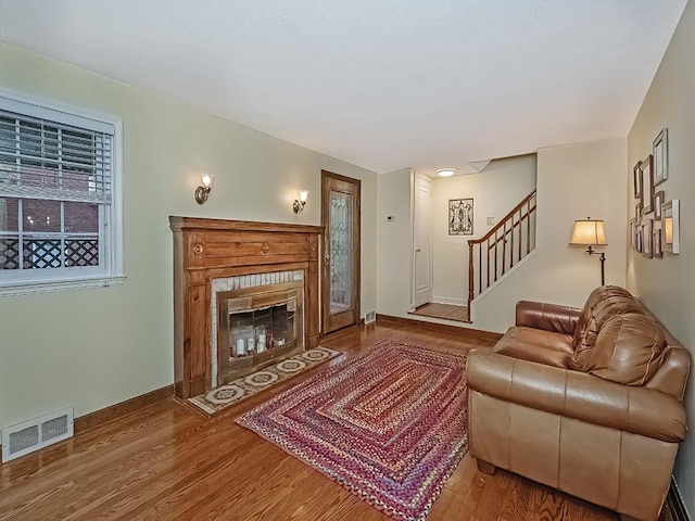 1907 Shaler Dr, Shaler, PA 15116 - living room with wood finished floors, stairway, and a glass covered fireplace