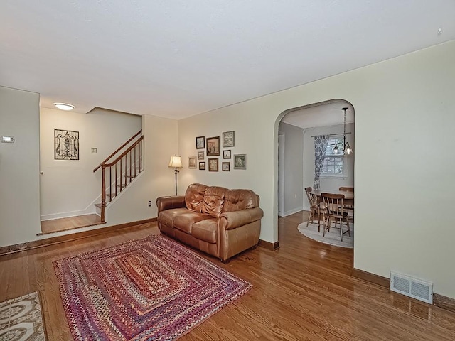 1907 Shaler Dr, Shaler, PA 15116 - living area featuring arched walkways, wood finished floors, and stairs