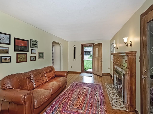 1907 Shaler Dr, Shaler, PA 15116 - living area with wood finished floors, arched walkways, and a fireplace