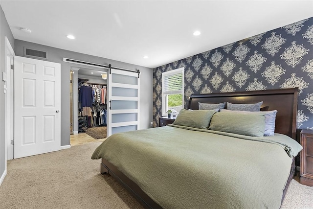 108 Oak Pointe Dr, Monroeville, PA 15146 - bedroom featuring a barn door, recessed lighting, carpet floors, a spacious closet, and wallpapered walls