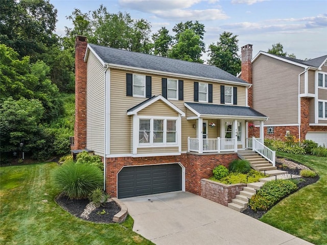 108 Oak Pointe Dr, Monroeville, PA 15146 - view of front of house with a chimney, concrete driveway, covered porch, a garage, and a front yard