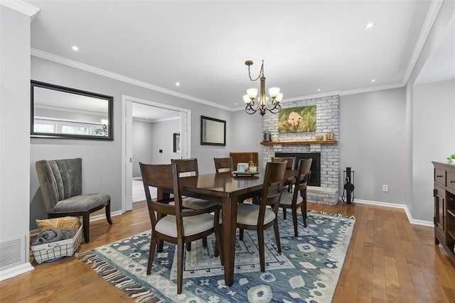 108 Oak Pointe Dr, Monroeville, PA 15146 - dining area featuring hardwood / wood-style flooring, a chandelier, recessed lighting, a fireplace, and ornamental molding