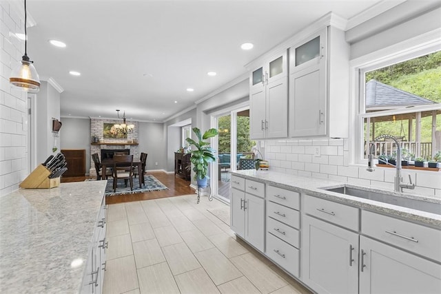 108 Oak Pointe Dr, Monroeville, PA 15146 - kitchen with ornamental molding, hanging light fixtures, white cabinetry, tasteful backsplash, and recessed lighting