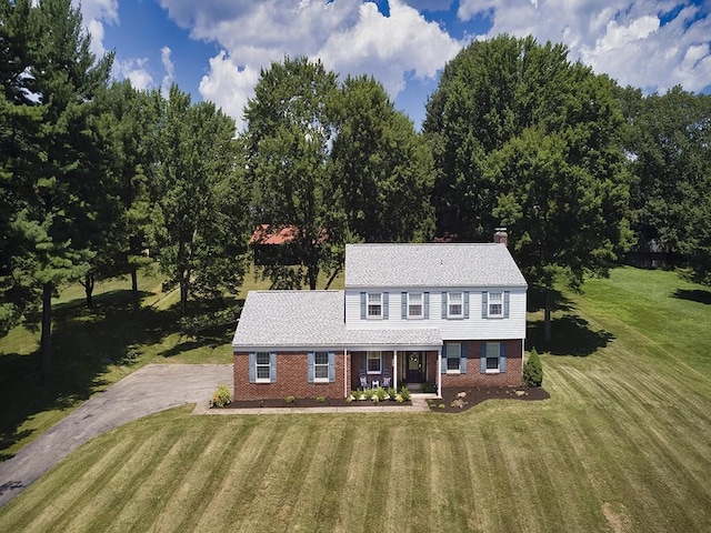 141 Clover Ln, Pine Twp, PA 15044 - view of front of home featuring brick siding, a chimney, a front yard, and covered porch