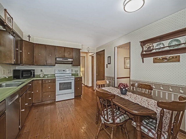 141 Clover Ln, Pine Twp, PA 15044 - kitchen with white electric range oven, dishwasher, wallpapered walls, under cabinet range hood, and dark wood-style flooring