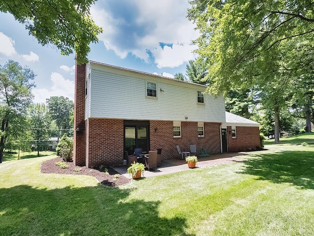 141 Clover Ln, Pine Twp, PA 15044 - back of property featuring a lawn, a patio, brick siding, and a chimney