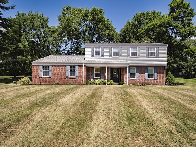 141 Clover Ln, Pine Twp, PA 15044 - view of front facade featuring brick siding, a front lawn, and covered porch