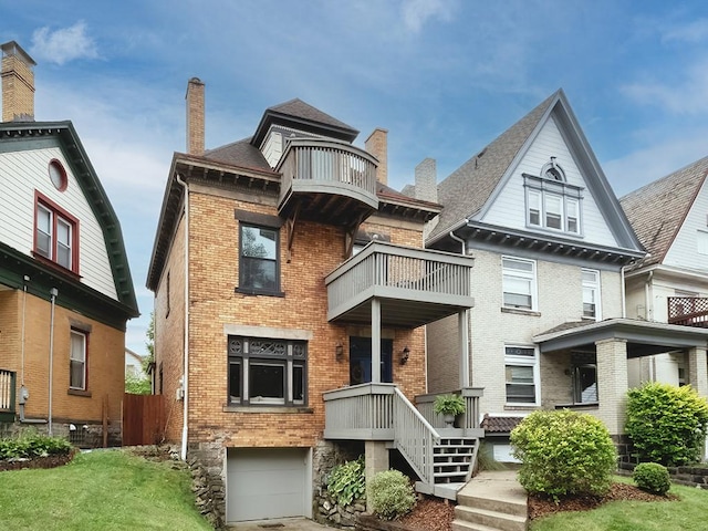 410 Bailey Ave, Mt Washington, PA 15211 - view of front facade with a balcony, brick siding, a garage, and driveway