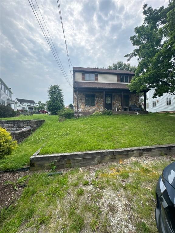 534 Independence Dr, Clairton, PA 15025 - view of front of home featuring stone siding and a front yard