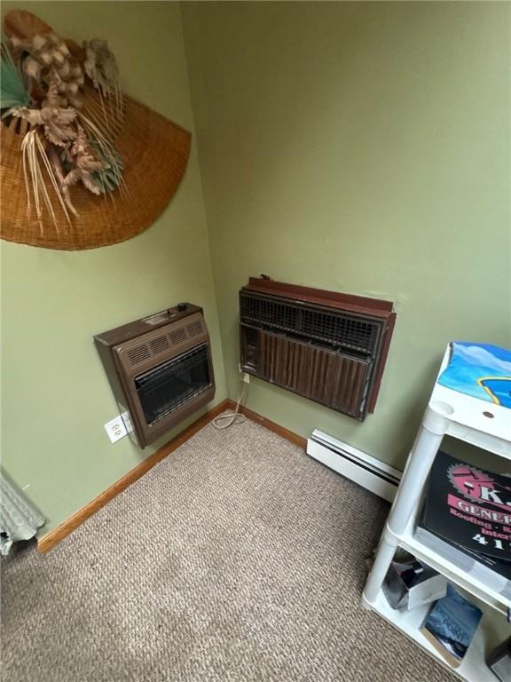 534 Independence Dr, Clairton, PA 15025 - detailed view of carpet flooring, a baseboard radiator, heating unit, a wall mounted AC, and a fireplace