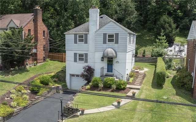 1155 Cedar Blvd, Mt Lebanon, PA 15228 - view of front of home featuring a garage, driveway, a chimney, and roof with shingles