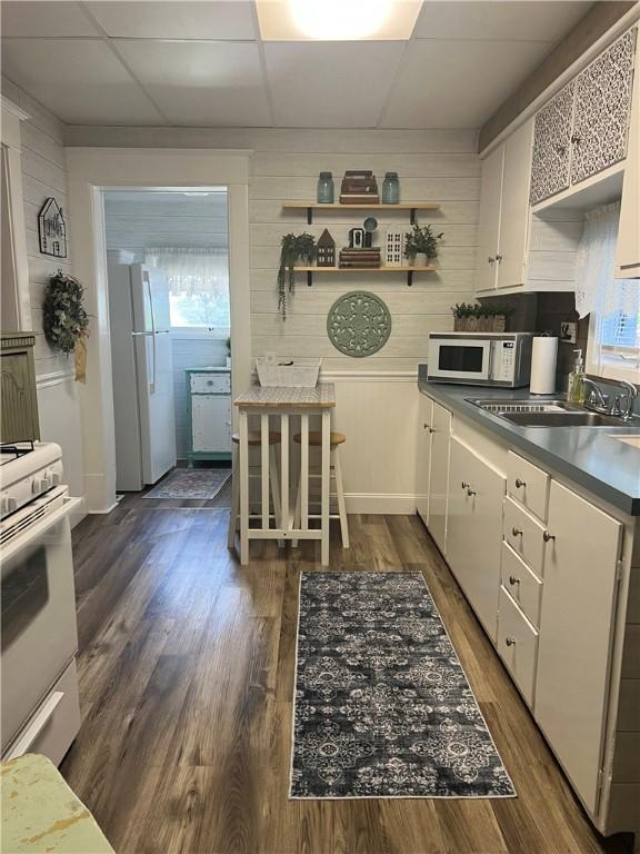 1220 Negley St, Farrell, PA 16121 - kitchen featuring white appliances, white cabinets, a paneled ceiling, dark wood-type flooring, and open shelves
