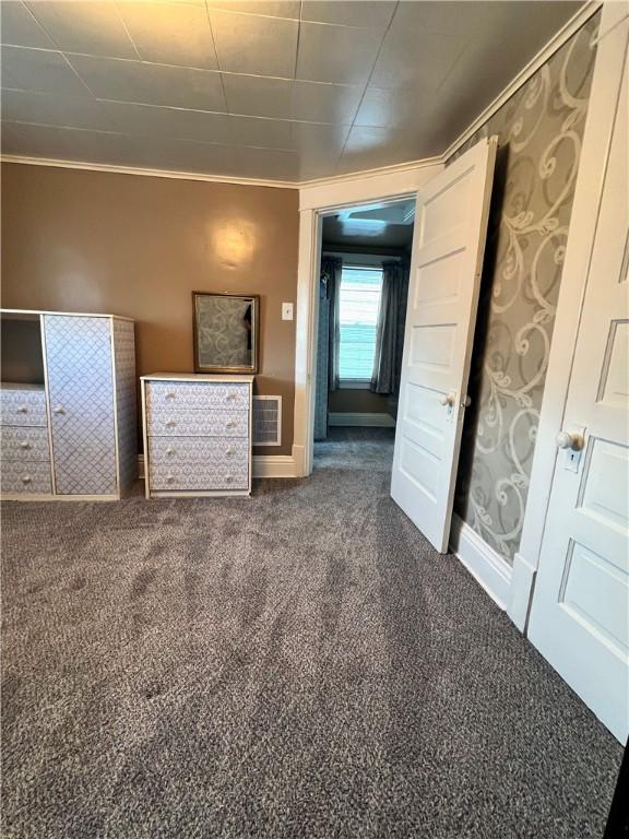 1220 Negley St, Farrell, PA 16121 - unfurnished bedroom with crown molding and dark carpet