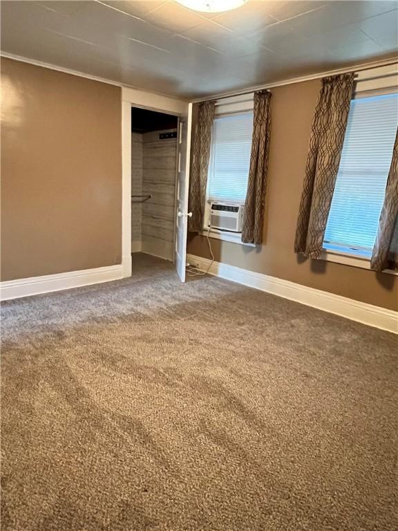 1220 Negley St, Farrell, PA 16121 - unfurnished bedroom featuring cooling unit, carpet, crown molding, and a closet