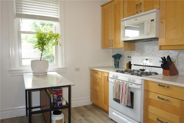 540 Mifflin Ave, Regent Square, PA 15221 - kitchen featuring white appliances, healthy amount of natural light, backsplash, and light countertops