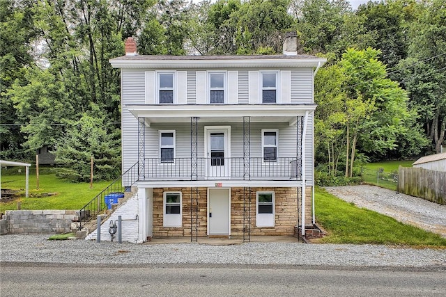 881 Main St, North Huntingdon, PA 15642 - view of property featuring a chimney, stairway, stone siding, and a porch