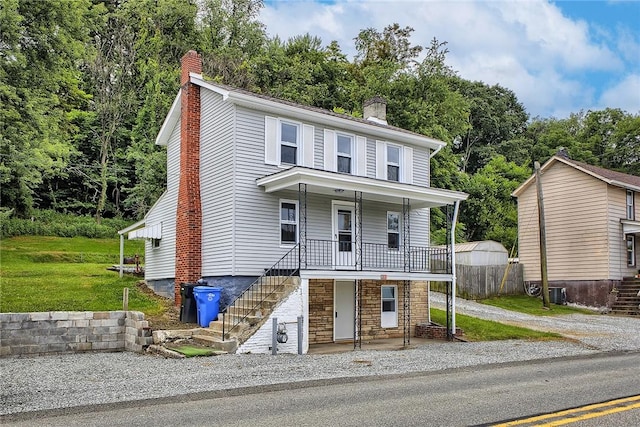 881 Main St, North Huntingdon, PA 15642 - view of front of house featuring a chimney, stairs, a porch, and stone siding