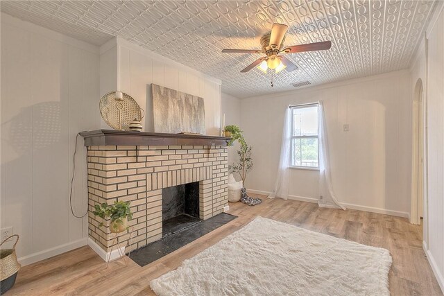 881 Main St, North Huntingdon, PA 15642 - living area with a ceiling fan, a brick fireplace, wood finished floors, and an ornate ceiling