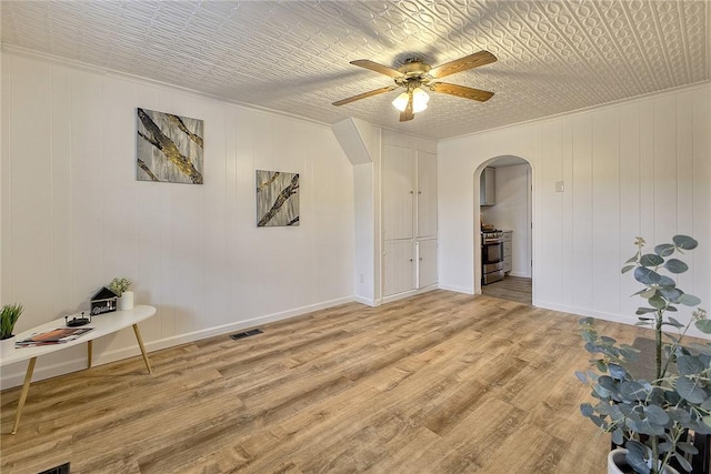 881 Main St, North Huntingdon, PA 15642 - unfurnished room with arched walkways, a ceiling fan, light wood-style flooring, and ornamental molding