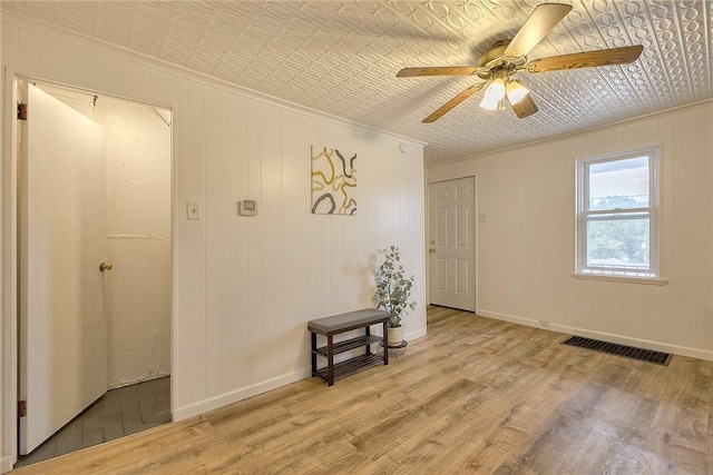 881 Main St, North Huntingdon, PA 15642 - empty room featuring wood finished floors, ceiling fan, an ornate ceiling, and crown molding