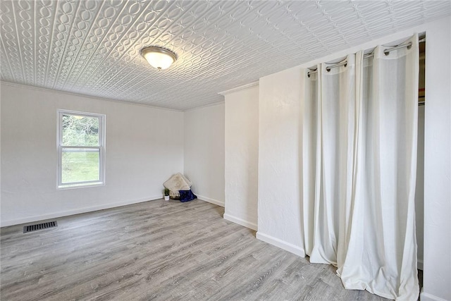 881 Main St, North Huntingdon, PA 15642 - empty room featuring an ornate ceiling, wood finished floors, and ornamental molding