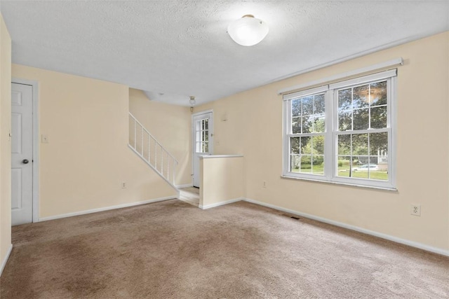 3080 E Bardonner Rd, Hampton, PA 15044 - empty room featuring a textured ceiling, stairway, and carpet flooring