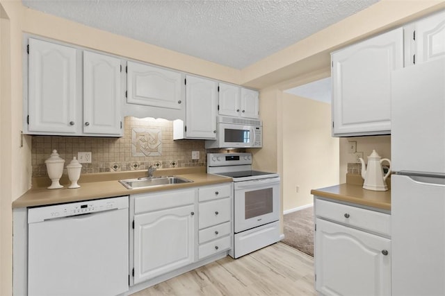 3080 E Bardonner Rd, Hampton, PA 15044 - kitchen featuring white appliances, light wood-type flooring, a textured ceiling, white cabinetry, and decorative backsplash