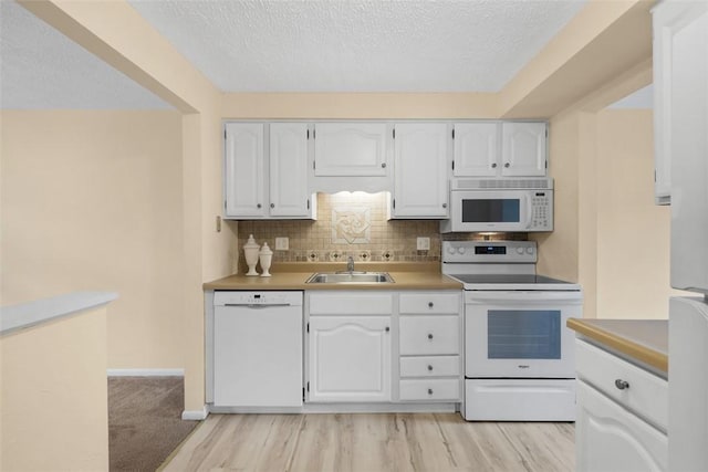 3080 E Bardonner Rd, Hampton, PA 15044 - kitchen featuring white appliances, white cabinets, a textured ceiling, and backsplash