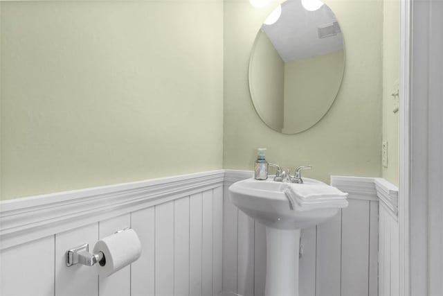 3080 E Bardonner Rd, Hampton, PA 15044 - bathroom with wainscoting and a decorative wall