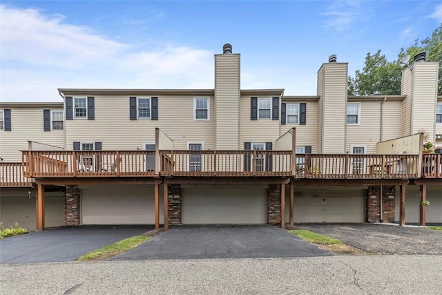 3080 E Bardonner Rd, Hampton, PA 15044 - rear view of property with an attached garage, driveway, a wooden deck, and a chimney