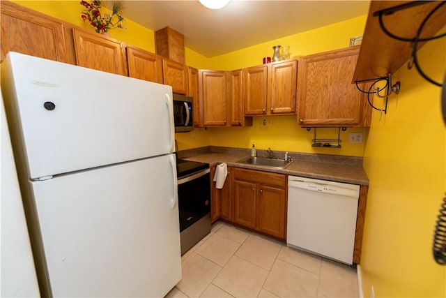 425 N Neville St Unit 302, Oakland, PA 15213 - kitchen featuring stainless steel appliances, light tile patterned floors, brown cabinets, and dark countertops
