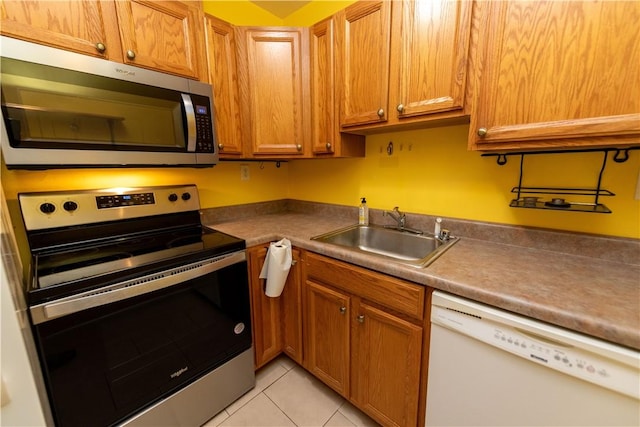 425 N Neville St Unit 302, Oakland, PA 15213 - kitchen featuring stainless steel appliances, light tile patterned floors, and brown cabinetry