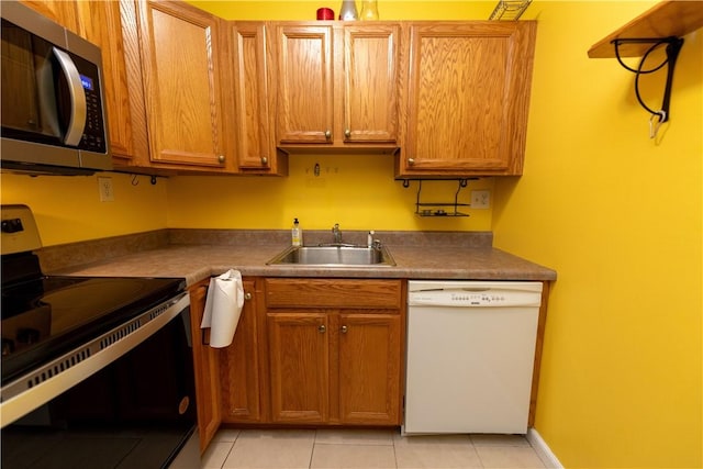 425 N Neville St Unit 302, Oakland, PA 15213 - kitchen with appliances with stainless steel finishes, light tile patterned floors, and brown cabinetry