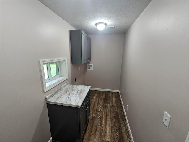 352 Hartzell School Rd, Marion Twp, PA 16123 - laundry area featuring washer hookup, a textured ceiling, dark wood finished floors, and cabinet space