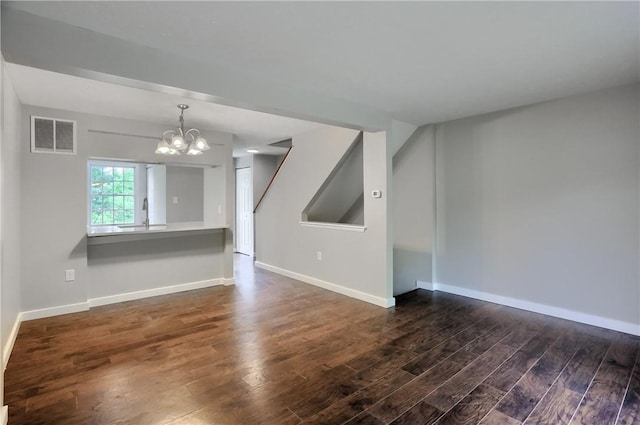 7311 Lafayette Sq, Hopewell Twp, PA 15001 - unfurnished living room featuring dark wood-type flooring and a chandelier