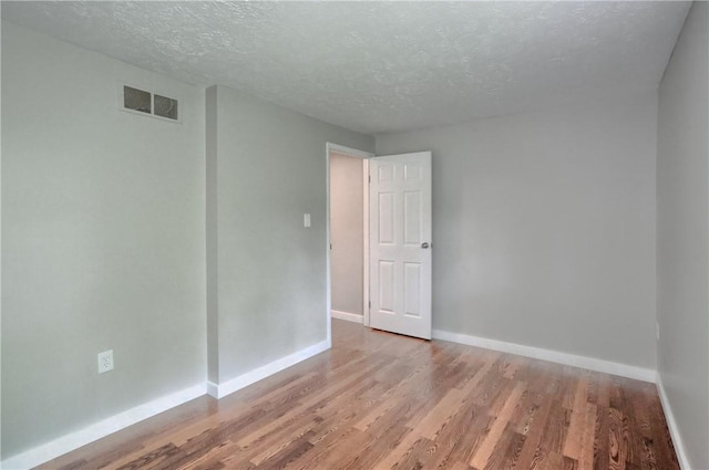 7311 Lafayette Sq, Hopewell Twp, PA 15001 - unfurnished room featuring wood finished floors and a textured ceiling