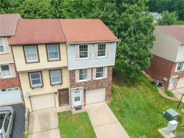 7311 Lafayette Sq, Hopewell Twp, PA 15001 - view of front of house with driveway, a front lawn, brick siding, and an attached garage