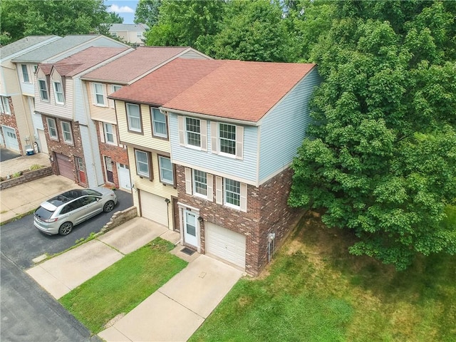 7311 Lafayette Sq, Hopewell Twp, PA 15001 - view of front of house with a garage, concrete driveway, brick siding, roof with shingles, and a front yard