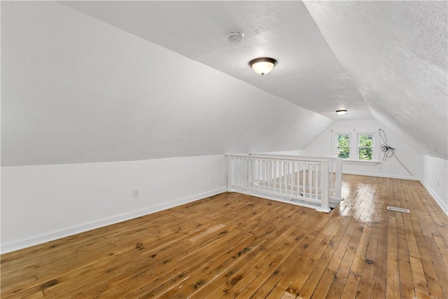 428 Card Ave, Wilmerding, PA 15148 - bonus room with lofted ceiling, hardwood / wood-style floors, and a textured ceiling
