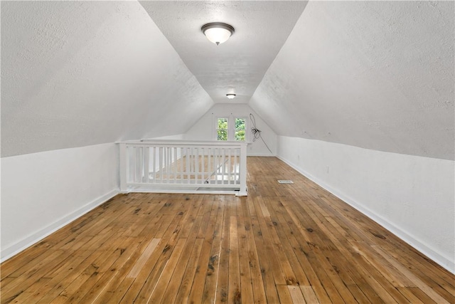 428 Card Ave, Wilmerding, PA 15148 - bonus room with a textured ceiling, hardwood / wood-style flooring, and vaulted ceiling